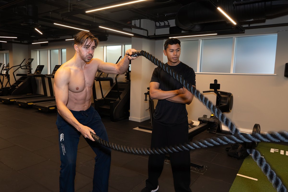 Joel Nathan coaching battle ropes during a gym-based training session