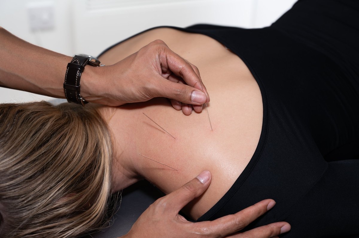 Joel Nathan delivering hands-on massage treatment to a patient in the Birmingham clinic