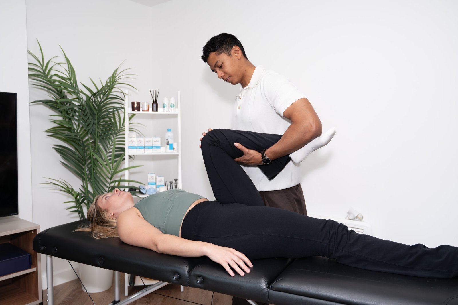 Joel Nathan carrying out a one-to-one physiotherapy assessment on a patient in his Birmingham clinic